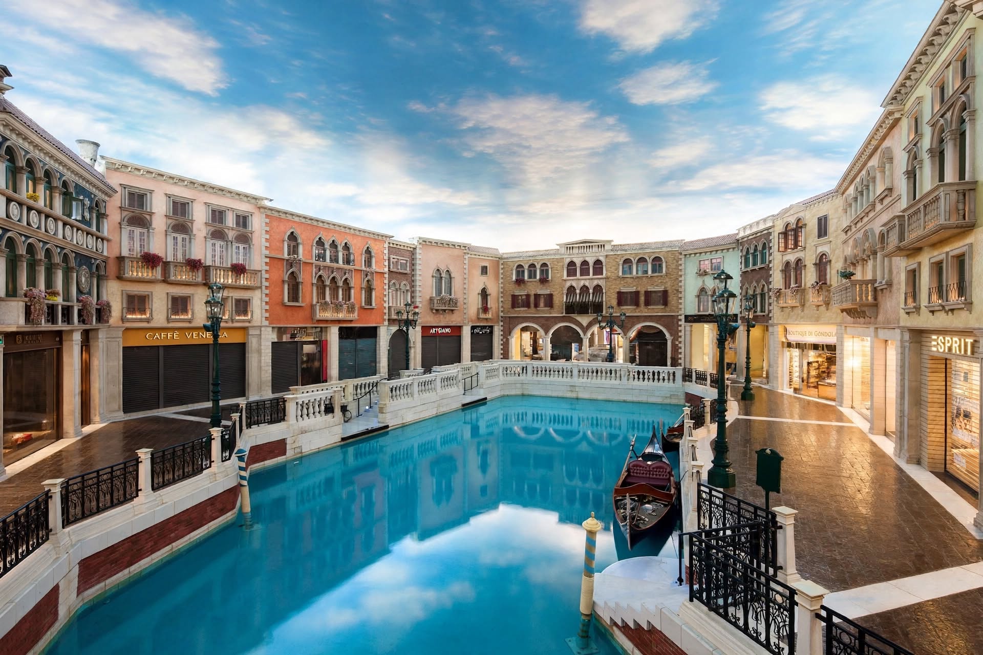 Interior canal with gondola and painted sky ceiling inside The Venetian Macao